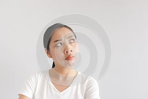 Sulk and grumpy face expression of woman in white t-shirt. Concept of offended peevish and sulky