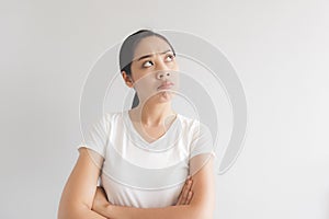 Sulk and grumpy face expression of woman in white t-shirt. Concept of offended peevish and sulky