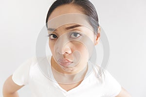 Sulk and grumpy face expression of woman in white t-shirt. Concept of offended peevish and sulky