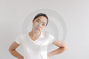 Sulk and grumpy face expression of woman in white t-shirt. Concept of offended peevish and sulky