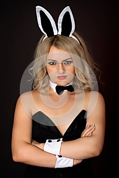 Sullen girl in bunny costume photo