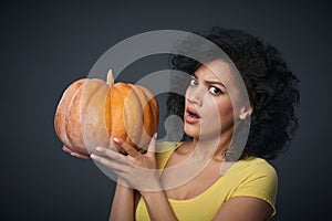 Sullen woman holding pumpkin photo