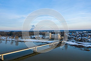 The Sully sur Loire bridge and its town center under the snow in Europe, in France, in the Center region, in the Loiret, towards
