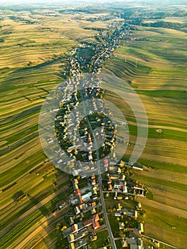 Suloszowa village among farm fields at sunset, aerial view of Krakow County, Poland