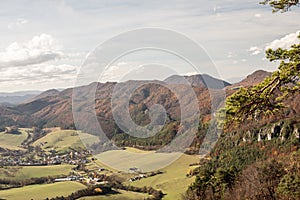 Sulov-Hradna village with partly rocky hills covered by colorful forest in Slovakia during autumn