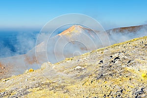 Sulphur fumaroles on the top of the volcano crate photo