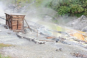 Sulphurous mountain valley with hot spring stream and steam at Tamagawa Onsen Hot spring in Senboku city, Akita prefecture, Japan