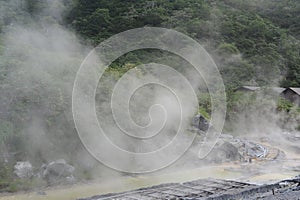 Sulphurous mountain valley with hot spring stream and steam at Tamagawa Onsen Hot spring in Senboku city, Akita prefecture, Tohoku