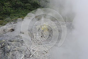 Sulphurous mountain valley with hot spring stream and steam at Tamagawa Onsen Hot spring in Senboku city, Akita prefecture, Tohoku