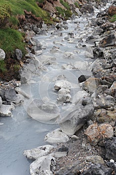 Sulphurous mountain valley with hot spring stream and steam at Tamagawa Onsen Hot spring in Senboku city, Akita prefecture, Tohoku