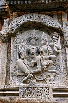 Sulpture Lakshmi sitting in the lap of Vishnu. Kedareshwara Temple, Halebid, Karnataka North Wall.