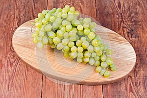 Sultana grapes cluster on the oval wooden serving board