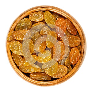 Sultanas, golden raisins, in wooden bowl