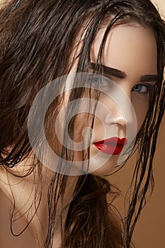 Sultry look of model with damp wet hair & make-up