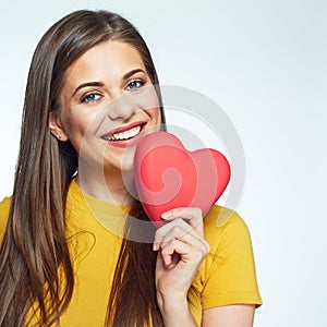 Sumbol of love. Smiling woman holding heart.