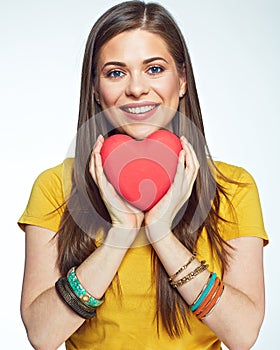 Sumbol of love. Smiling woman holding heart.