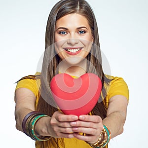 Sumbol of love. Smiling woman holding heart.
