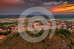 Sumeg, Hungary - Aerial panoramic view of the famous High Castle of Sumeg in Veszprem county at sunset with storm clouds