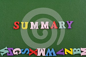 SUMMARY word on green background composed from colorful abc alphabet block wooden letters, copy space for ad text. Learning