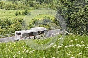 Summe or spring fun bus sustainable traveling blurring movement relaxing vacation in the reen grass rural national park