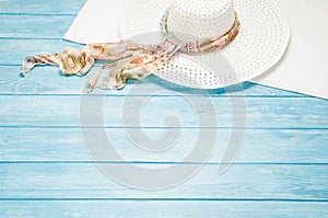 Summer accessories and tourism concept, top view on wooden background