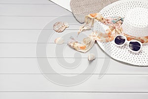 Summer accessories and tourism concept, top view on wooden background