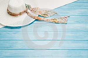 Summer accessories and tourism concept, top view on wooden background