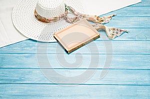 Summer accessories and tourism concept, top view on wooden background