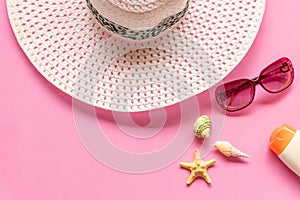 Summer accessories. White big hat and sunbath go to travel in the beach. Tropical sea. Unusual top view.