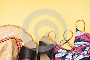 Summer Accessories on Yellow Background Summer Straw Hat Women Beach Shoes Swimsuit Horizontal Copy Space Vacation Background