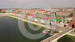 Summer aerial view of peculiar colorful Bruges embankment in Yoshkar-Ola with residential buildings in Flemish