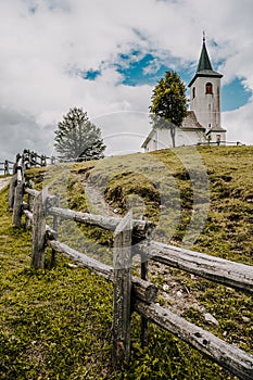 Summer alpine countryside landscape with high mountains and church. Logar valley Logarska Dolina from the panoramic road, Solcav