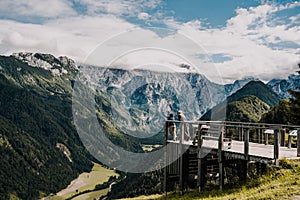 Summer alpine countryside landscape with high mountains and farms in the forest glade. Logar valley Logarska Dolina from the pan