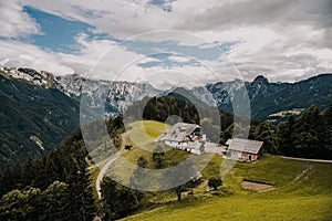 Summer alpine countryside landscape with high mountains and farms in the forest glade. Logar valley Logarska Dolina from the pan