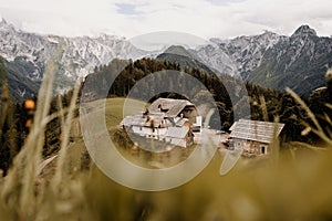 Summer alpine countryside landscape with high mountains and farms in the forest glade. Logar valley Logarska Dolina from the pan