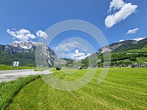 Summer austrian landscape with green meadows and Grimming mountain .2.351 m, an isolated peak in the Dachstein Mountains, in