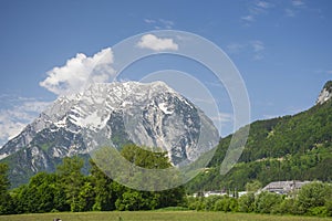 Summer austrian landscape with green meadows and Grimming mountain 2.351 m, an isolated peak in the Dachstein Mountains, in