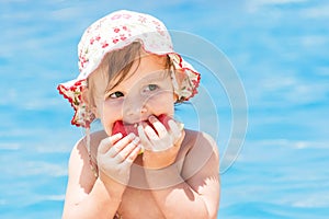 Summer baby girl eating watermelon