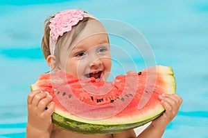 Summer baby girl eating watermelon
