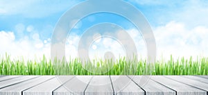 Summer backdrop with empty table, grass and sunny sky