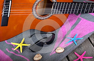 Summer background beach bar Acoustic guitar star hat and starfish on a wood