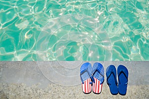 Summer background with flip flops near the pool