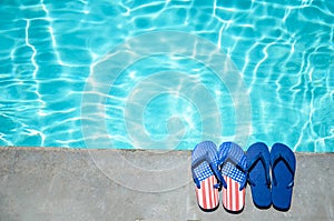 Summer background with flip flops near the pool