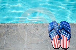 Summer background with flip flops near the pool