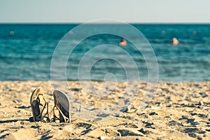 Summer background with flip flops on a sandy beach
