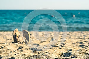 Summer background with flip flops on a sandy beach