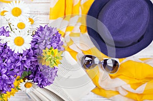 Summer background with flowers, book and womans accessories photo