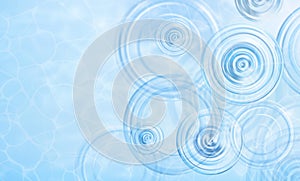 Summer background. Radial waves from a rain on water. Texture of water surface. Overhead view. Circles and rings on the