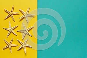 Summer background of yellow and blue paper with starfish, symbol