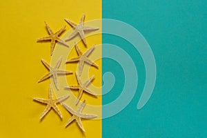 Summer background of yellow and blue paper with starfish, symbol